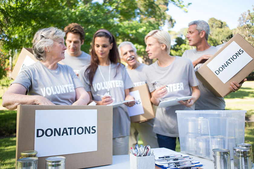happy volunteer family holding donation boxes