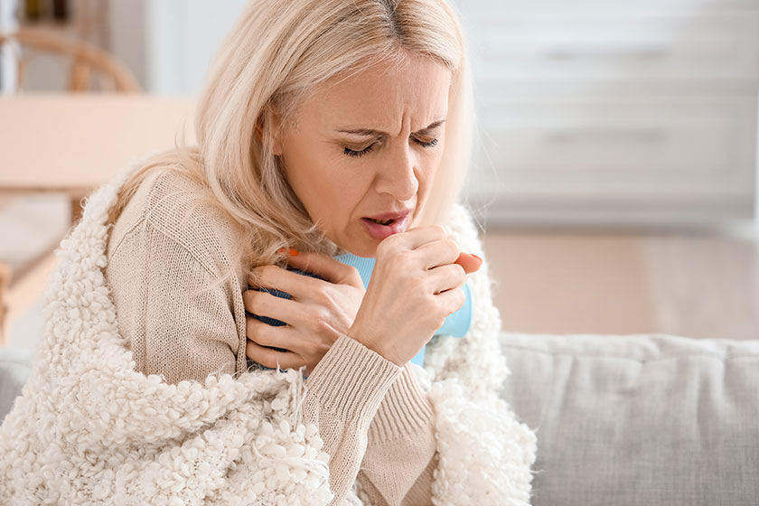 ill mature woman coughing home closeup
