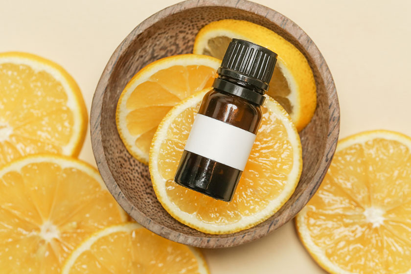 lemon essential oil little bottle lemon slices studio shot
