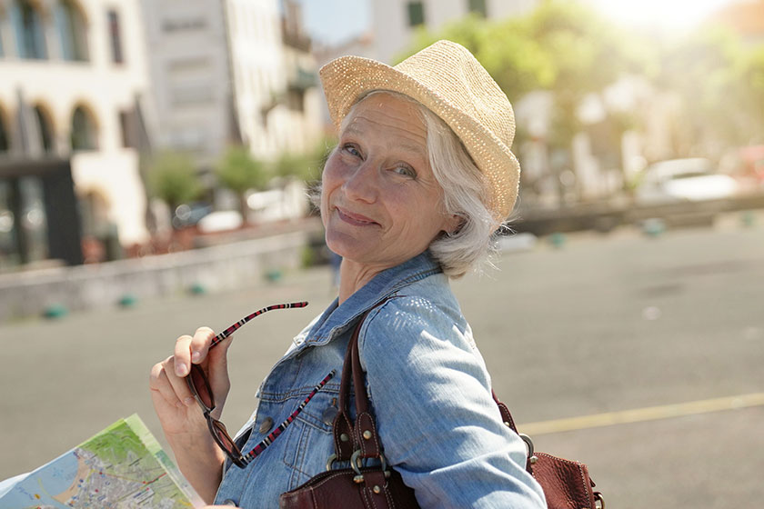 portrait senior woman visiting touristic town