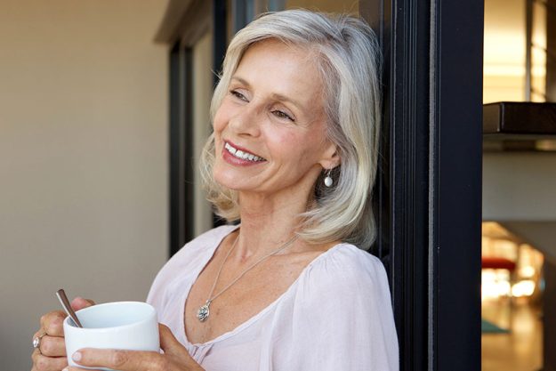 smiling older woman standing smiling older woman standing