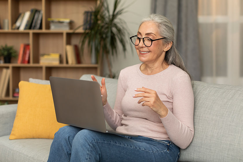 smiling pretty caucasian aged woman teacher glasses has online call