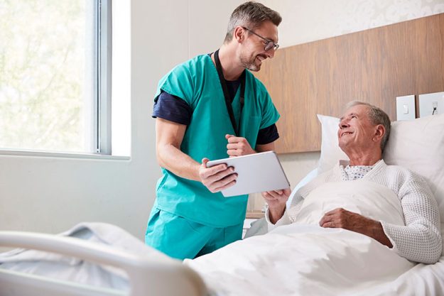 surgeon digital tablet visiting senior male patient hospital bed geriatric