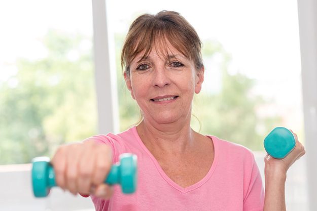 woman exercising with dumbbells