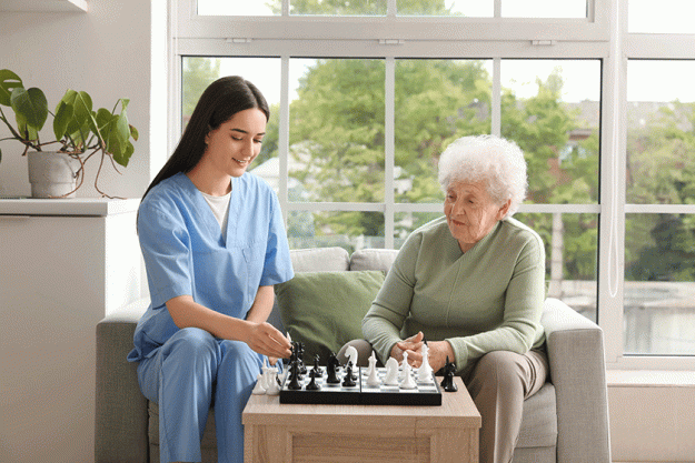 young nurse senior woman playing chess kitchen 