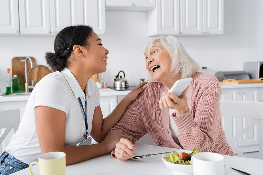 happy senior woman holding smartphone