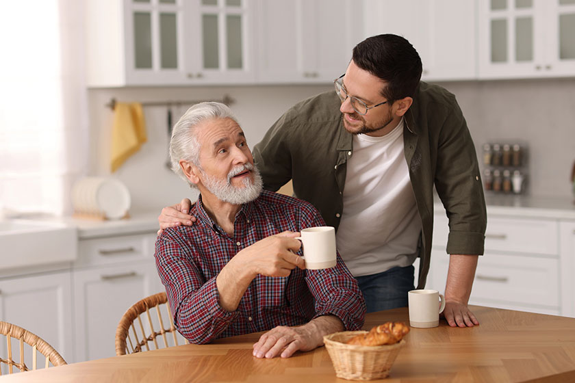 Happy son his dad wooden table kitchen