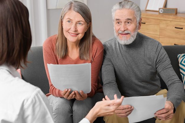 Insurance agent consulting elderly couple pension plan room Insurance agent consulting elderly couple pension plan room