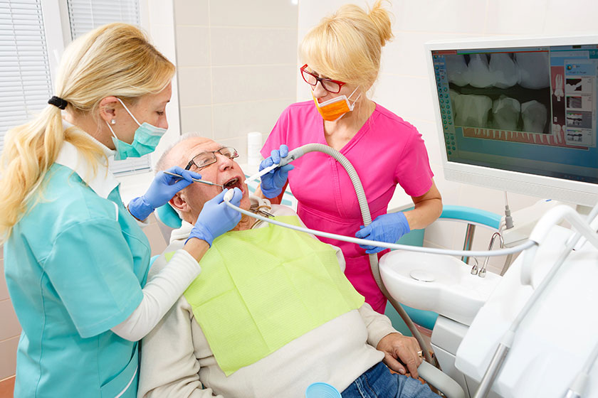 Old senior man dentist surgery having tooth operation stomatology clinic