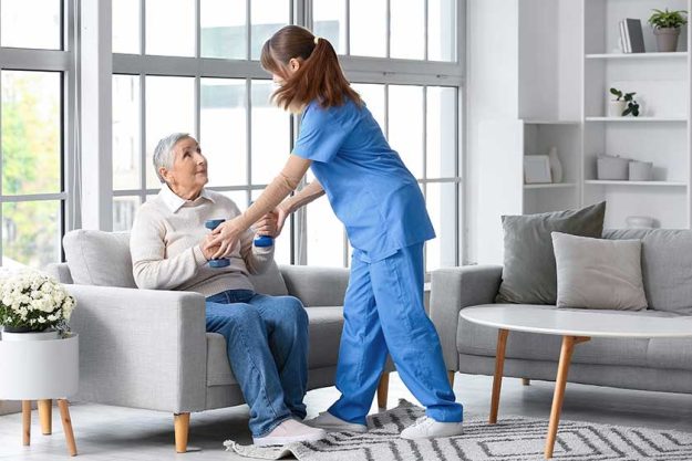 senior woman dumbbells caregiver home senior woman dumbbells caregiver home