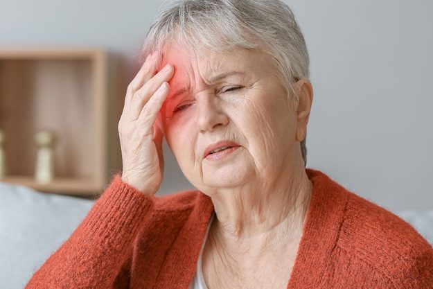 Senior woman suffering headache home Senior woman suffering headache home