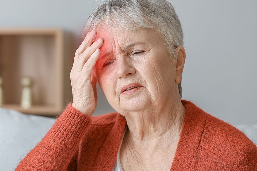 Senior woman suffering headache home