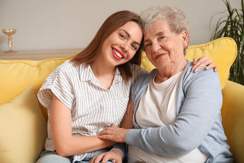 young woman her grandmother hugging home young woman her grandmother hugging home