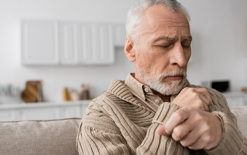 Depressed senior man parkinson disease sitting closed eyes home