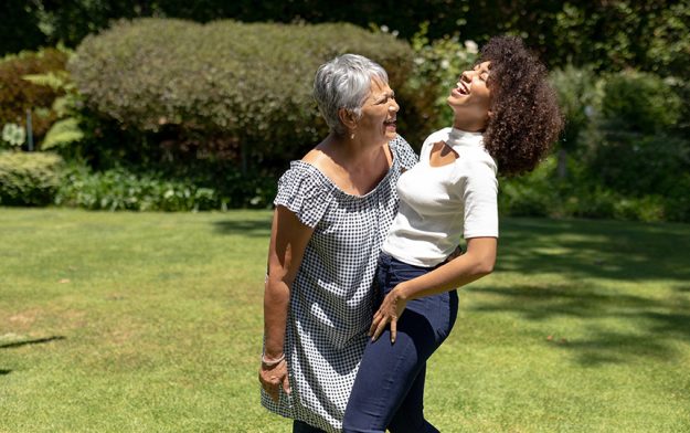 Front view senior mixed race woman her adult daughter standing