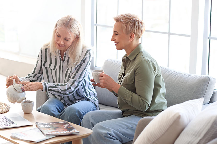Happy mature women drinking tea at home Happy mature women drinking tea at home