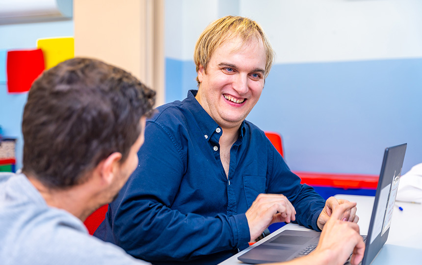 Happy mental disabled man teacher class day center people special