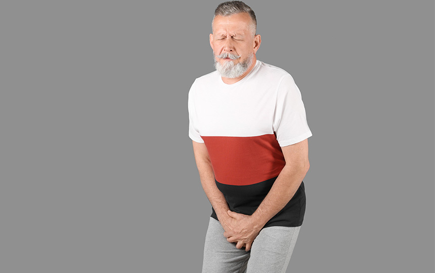 Mature man urological problems suffering pain grey background