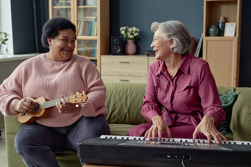 Portrait two joyful senior women playing music together enjoying creative Portrait two joyful senior women playing music together enjoying creative