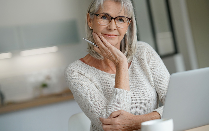 Senior woman at home websurfing