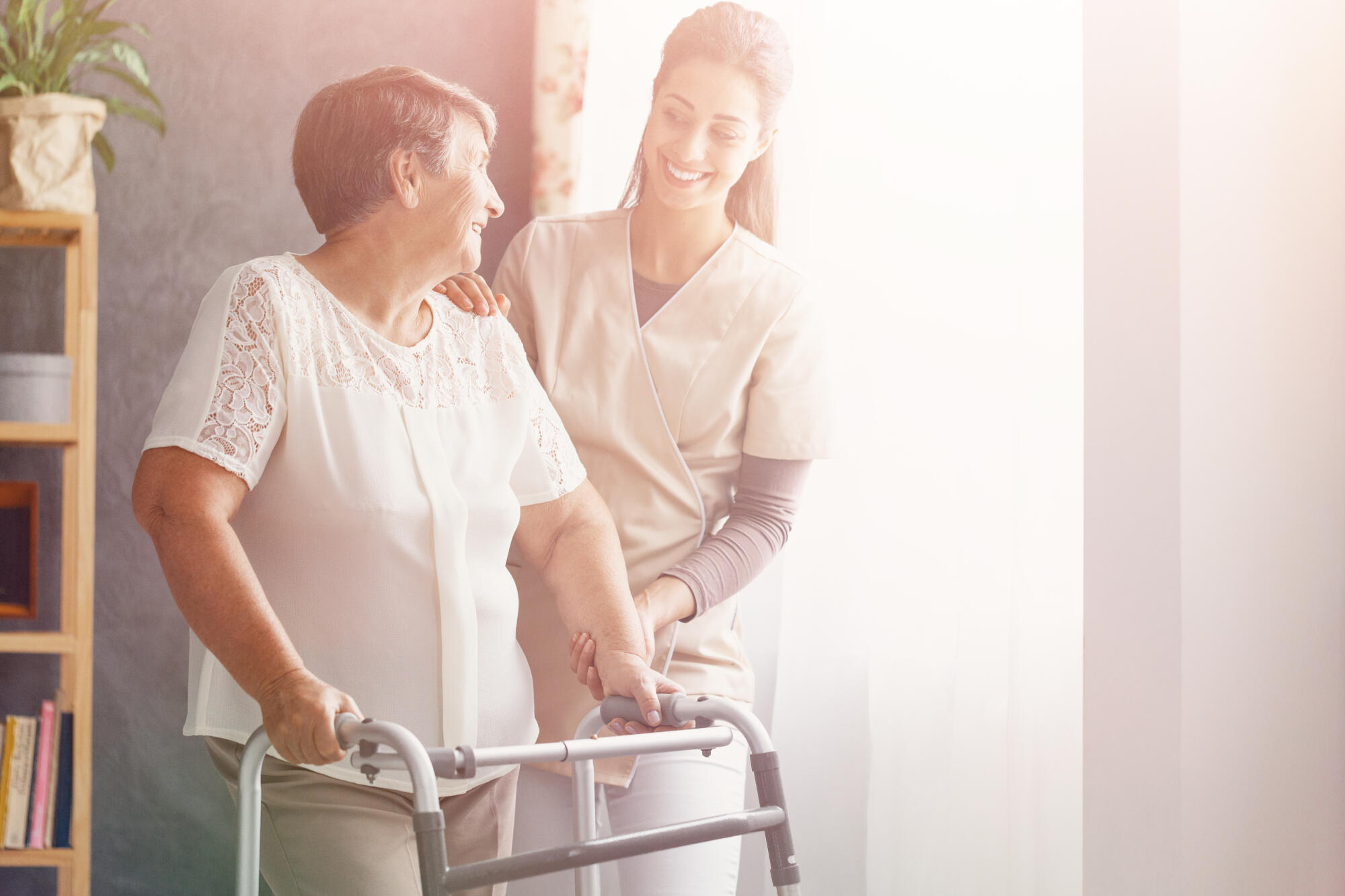 Smiling,Pretty,Caregiver,And,Old,Lady,With,Walker,At,Nursing Smiling,Pretty,Caregiver,And,Old,Lady,With,Walker,At,Nursing