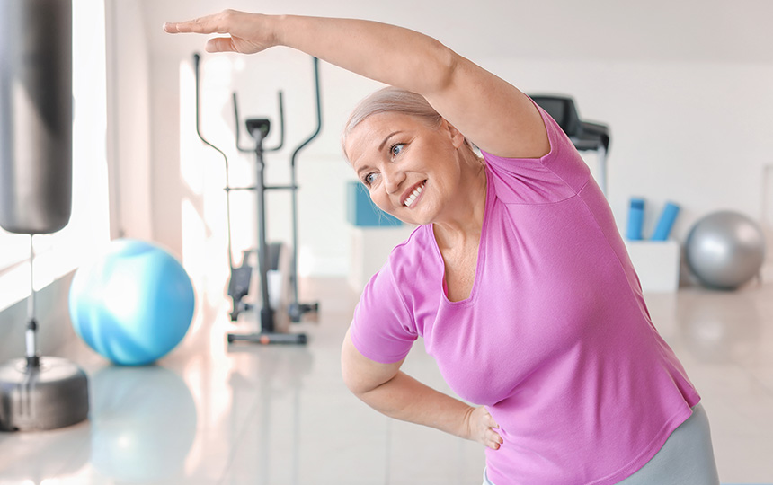 Sporty mature woman training in gym