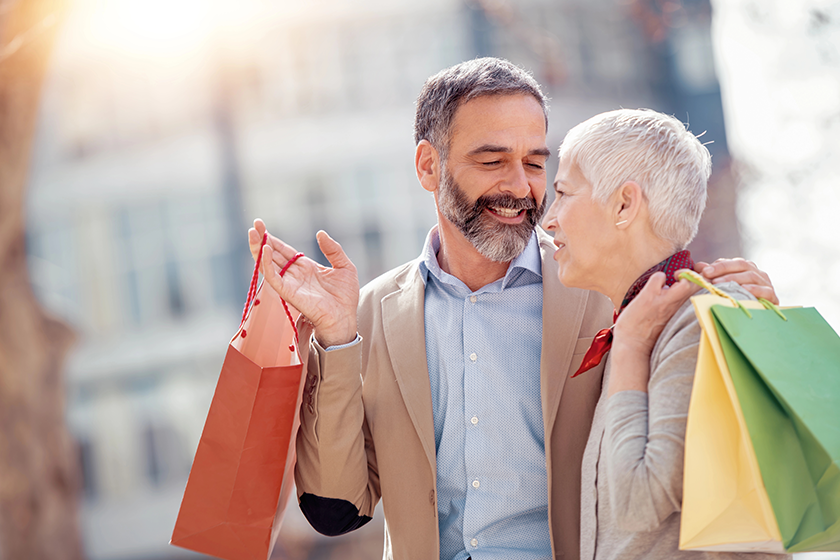 cheerful mature couple enjoying shopping together