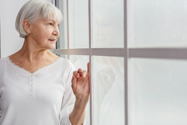cheerful pensioner watching at closed cheerful pensioner watching at closed