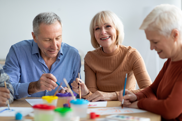 creative senior people enjoying painting class