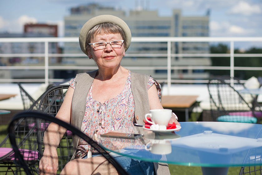 elderly woman enjoys cup coffee
