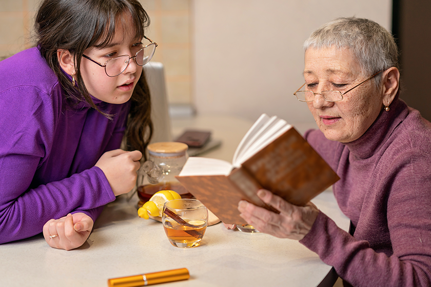 grandmother granddaughter drink tea