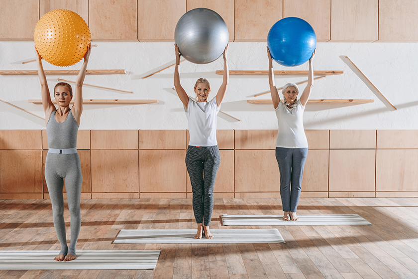 group senior people exercising fitness balls