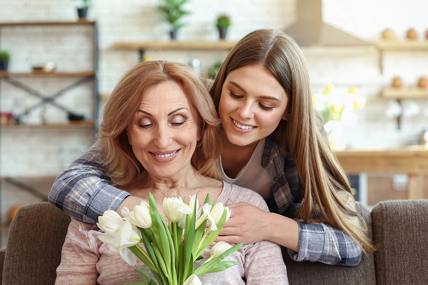 happy daughter and her mother with bouquet of flowers happy daughter and her mother with bouquet of flowers