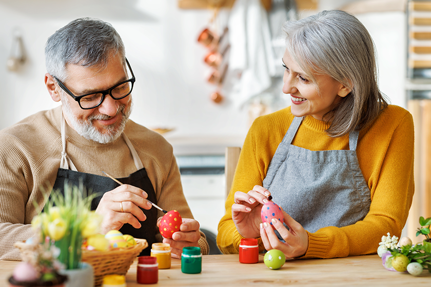 happy senior couple in kitchen decorate boiled eggs happy senior couple in kitchen decorate boiled eggs
