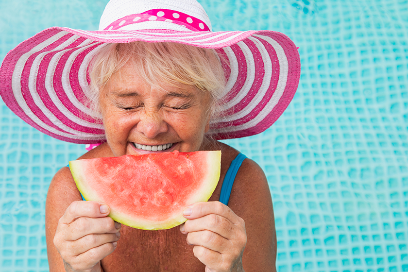 happy senior woman having party swimming pool