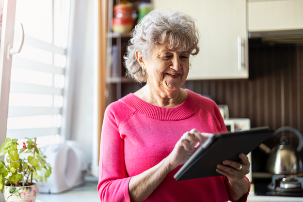 happy senior woman using digital tablet happy senior woman using digital tablet