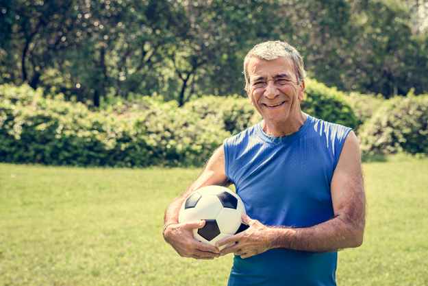 mature man holding football