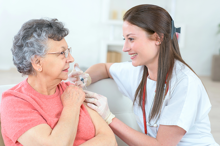 nurse giving injection to senior woman in the arm nurse giving injection to senior woman in the arm