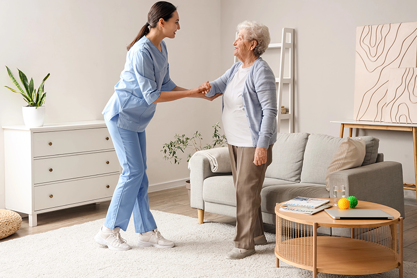 physical therapist helping senior woman walk physical therapist helping senior woman walk