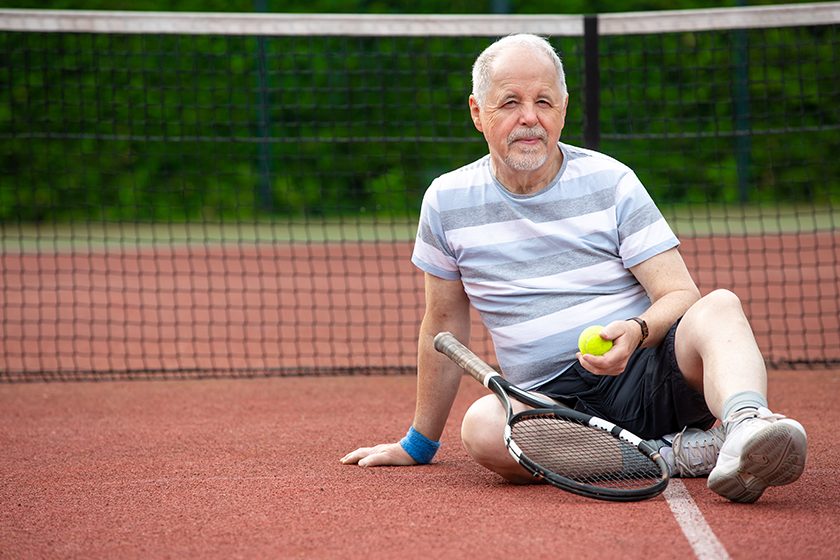 portrait of senior man playing tennis