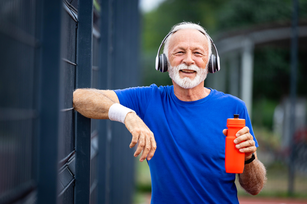 portrait senior man holding water bottle
