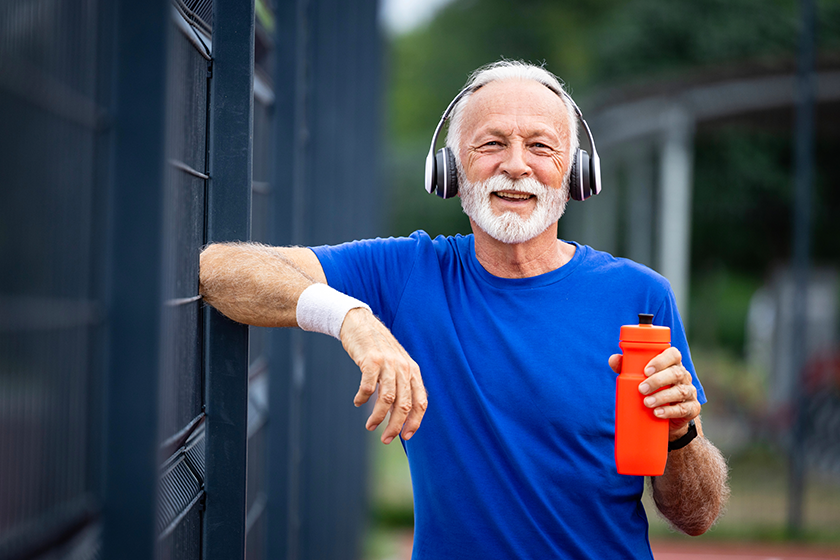portrait senior man holding water bottle