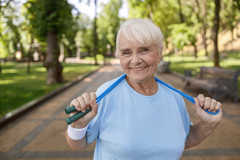 pretty senior lady with jump rope poses