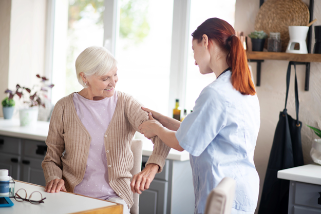 red haired caregiver massaging arms