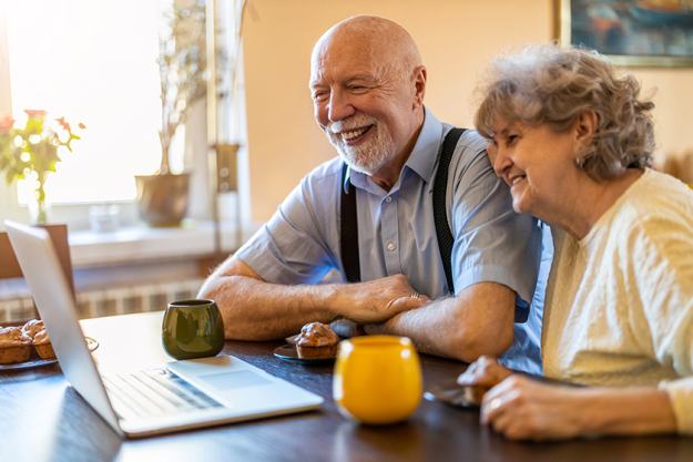 senior couple using laptop senior couple using laptop