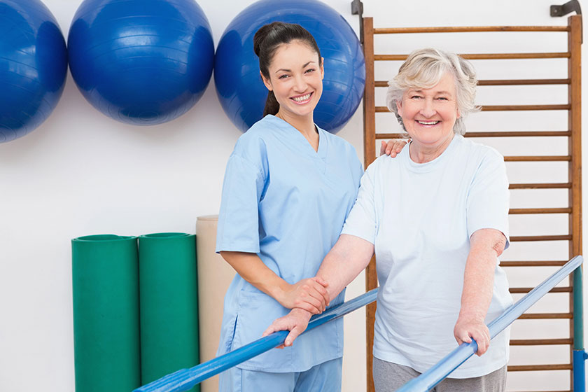 Senior woman and therapist looking at camera Senior woman and therapist looking at camera