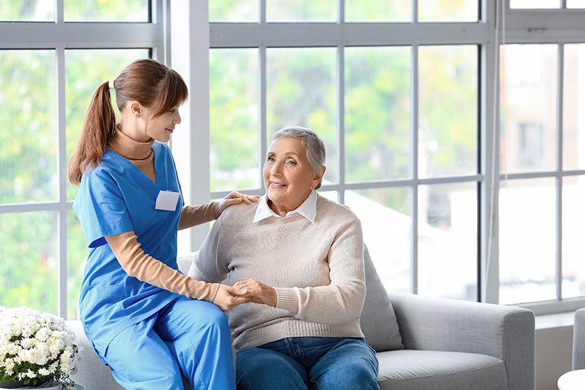 senior woman caregiver holding hands home