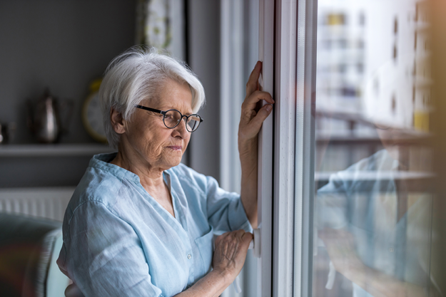 senior woman looking out window