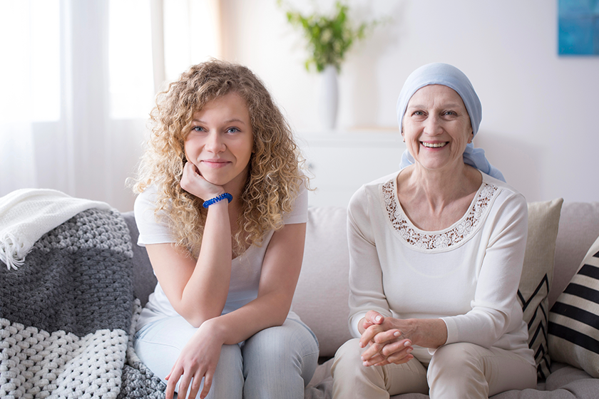 smiling girl sick woman ovarian cancer sitting sofa