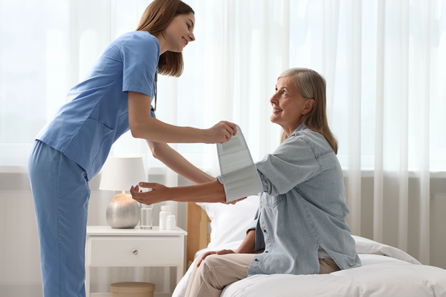 smiling healthcare worker measuring patient blood pressure smiling healthcare worker measuring patient blood pressure